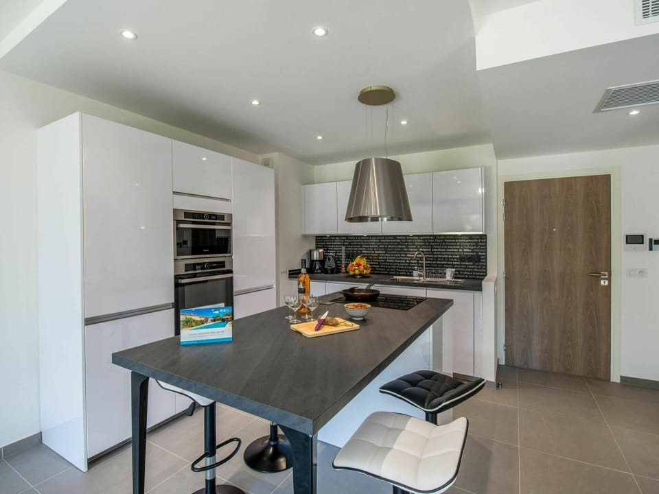 Table, Countertop, Furniture, Cabinetry, Kitchen, Home Appliance, Kitchen Stove, Wood, Interior Design, Lighting