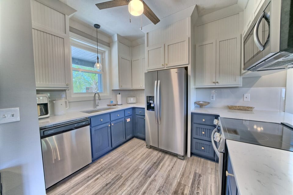 Modern kitchen with full-size refrigerator, dishwasher, microwave, and range. Includes coffee maker, toaster, and all cooking essentials.