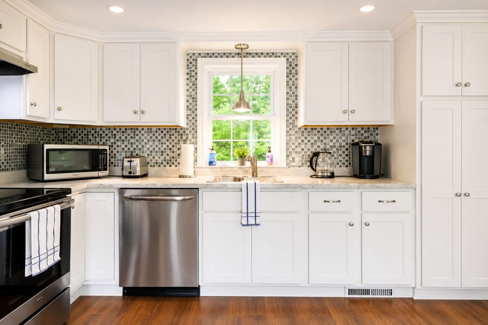 Bright modern kitchen with granite counters and stainless appliances
