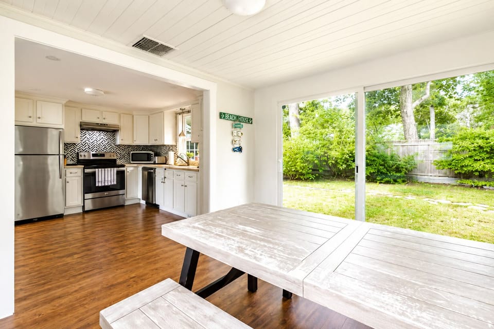 Bright dining space with backyard views and open kitchen access