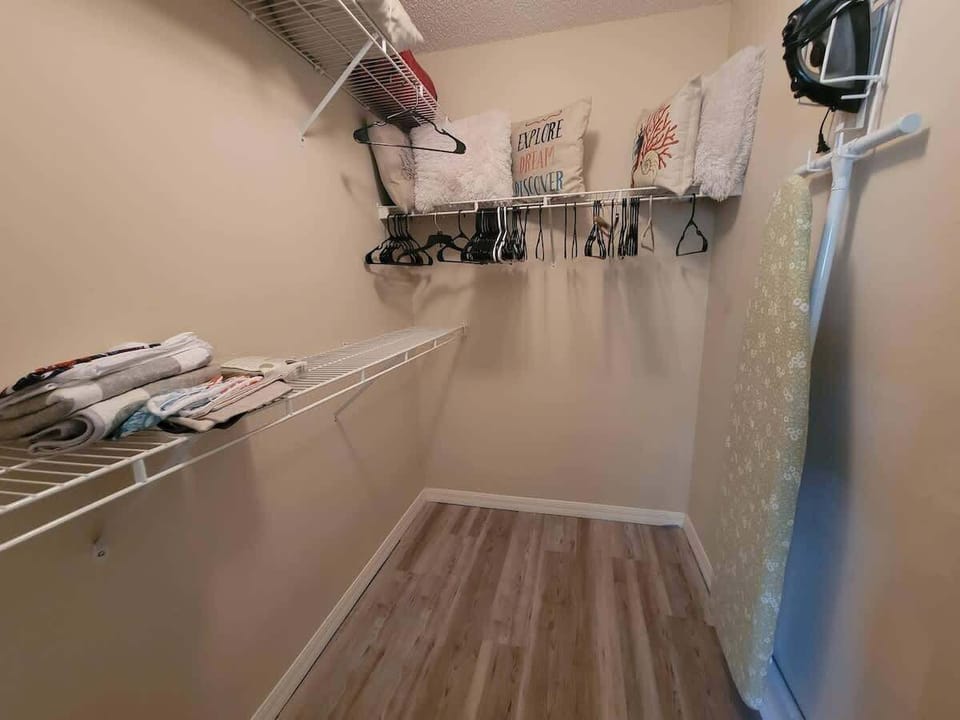 Primary Closet with iron board.