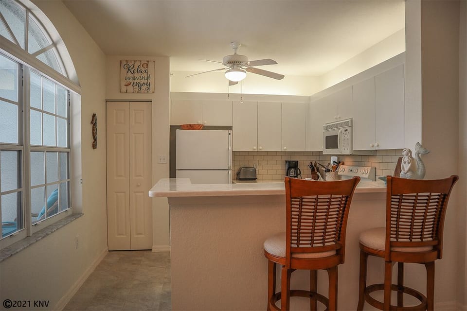 Large Fully Equipped Kitchen features a breakfast bar for two