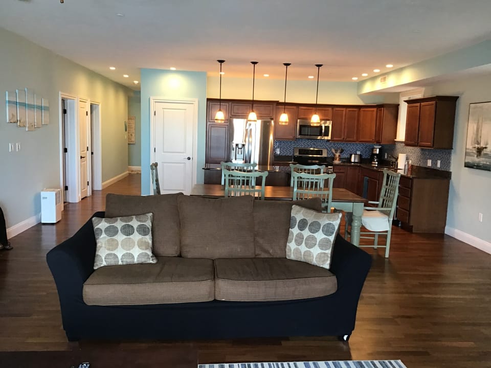 L02 has an open concept living room, dining room and kitchen with lake view