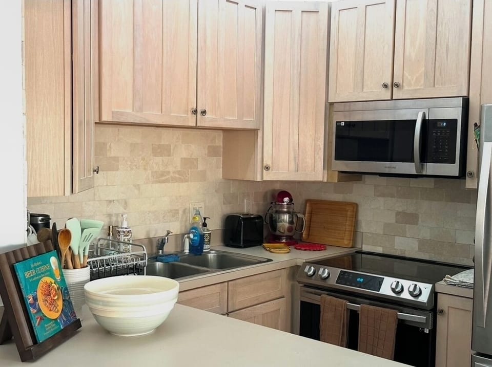 Kitchen, with newer stainless appliances open to the living space