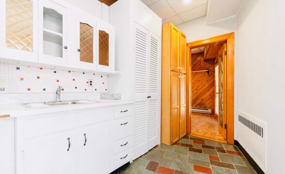 Continue down the hallway, wetbar now on left, leading to laundry room**
