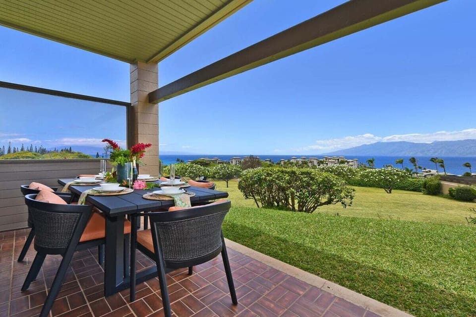 Outdoor lanai dining setup with ocean views, perfect for open-air meals.