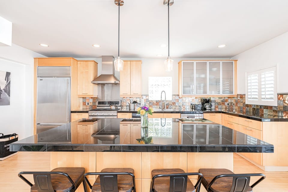 The kitchen includes a large island with barstool seating for four, making meal prep a social affair!
                