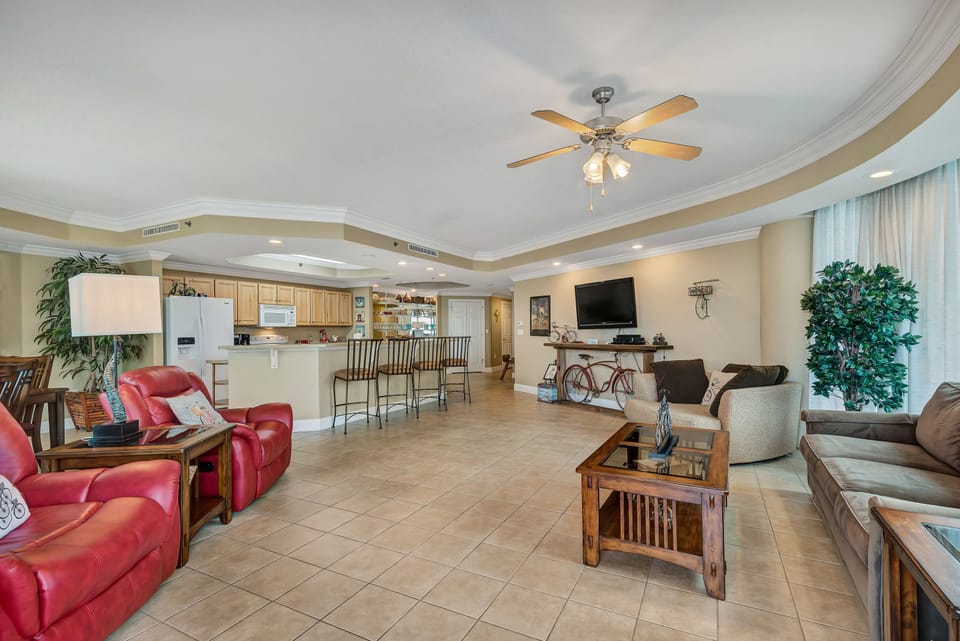 Discover a space where everyone can feel at home. This living area is a perfect blend of comfort and style, with a spacious layout that flows effortlessly into the kitchen and dining areas.
