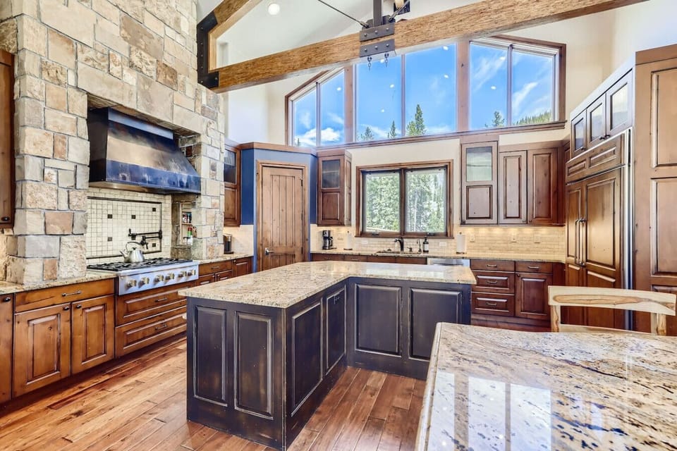 Gourmet kitchen with top-of-the-line appliances and ample counter space, perfect for preparing meals and entertaining guests.