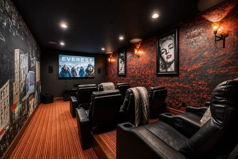 Enjoy a cinematic experience in the luxury home theater with plush seating and a large screen, perfect for family movie nights or gaming.