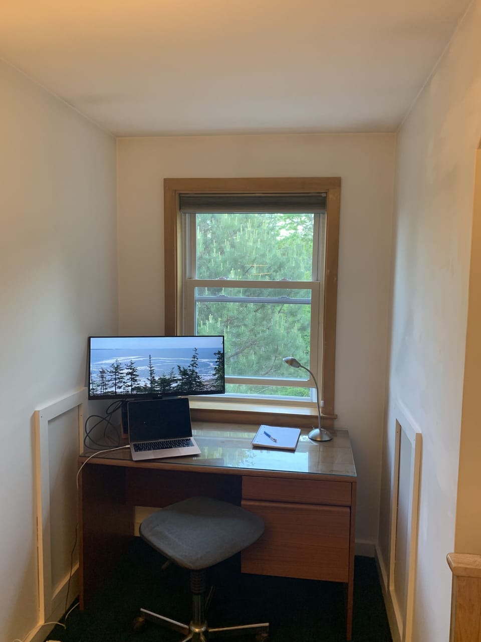 In the room with the bunk bed, a desk with extra-wide monitor.