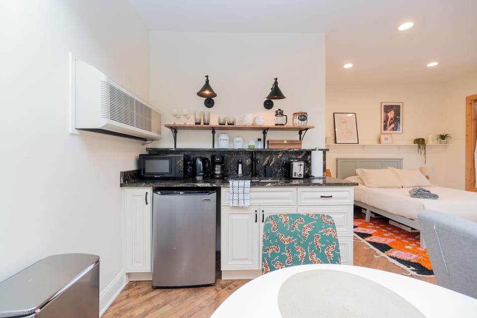 Kitchenette with mini-fridge, microwave, toaster, tea kettle, and coffee maker