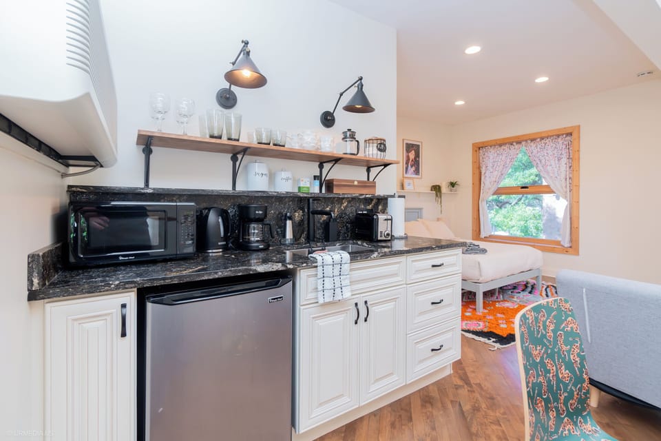 Kitchenette with mini-fridge, microwave, toaster, tea kettle, and coffee maker