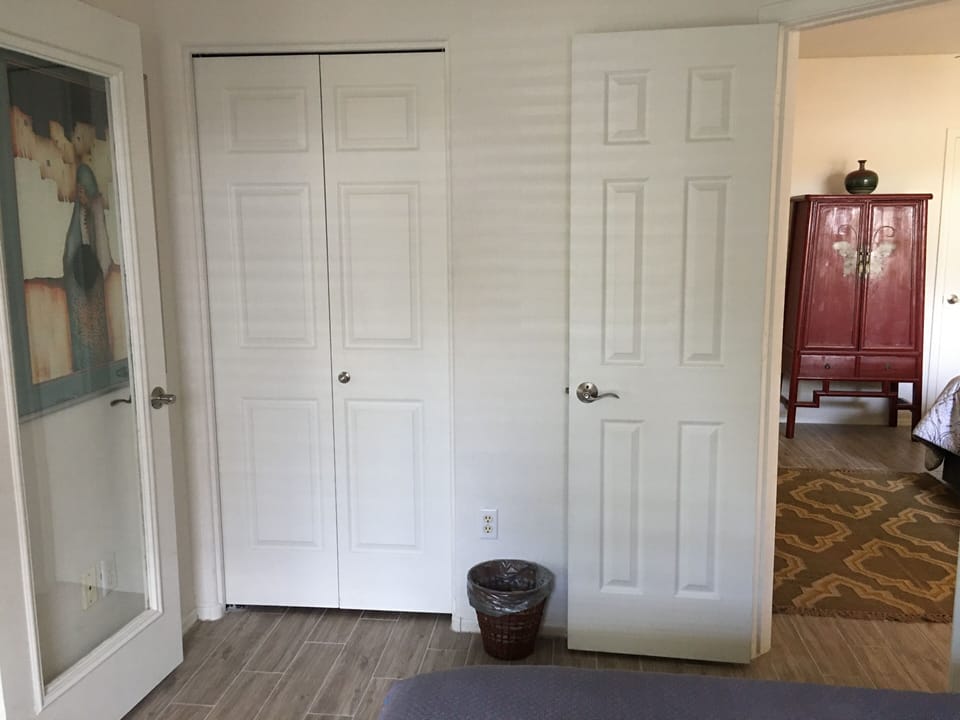Second bedroom closet with dresser inside.