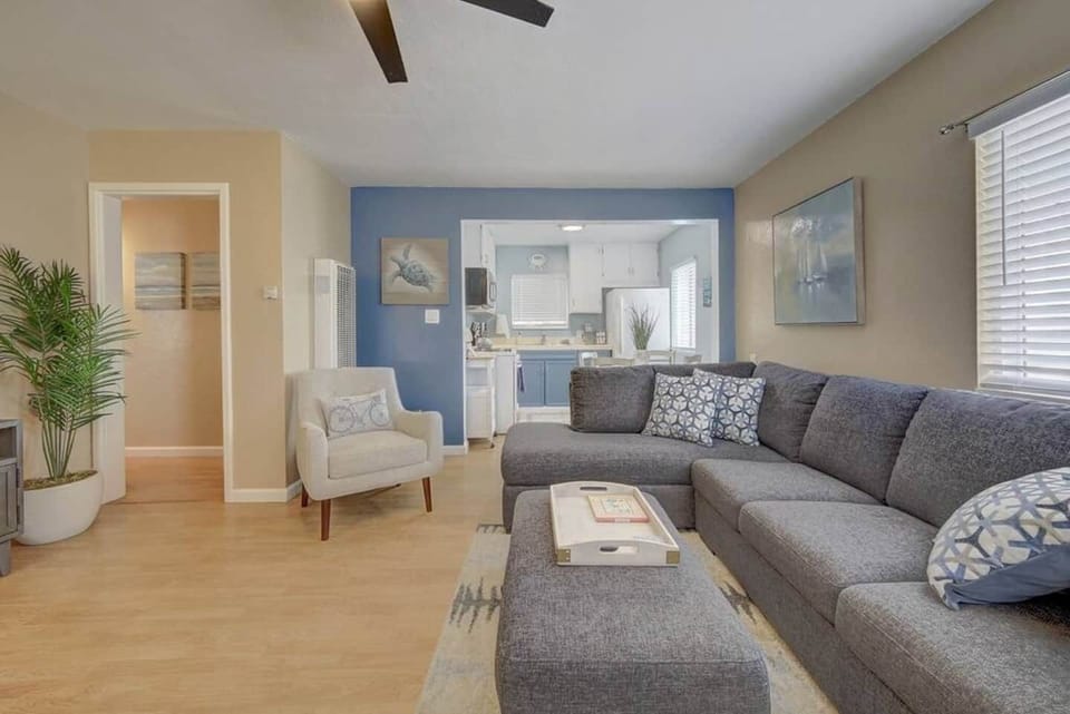 View from front door of living room and kitchen. Bright and airy apartment with great air flow and ceiling fans. 