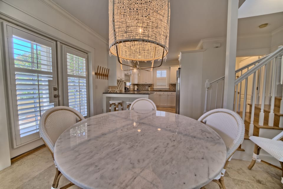 Kitchen table has 6 bistro chairs for dining.