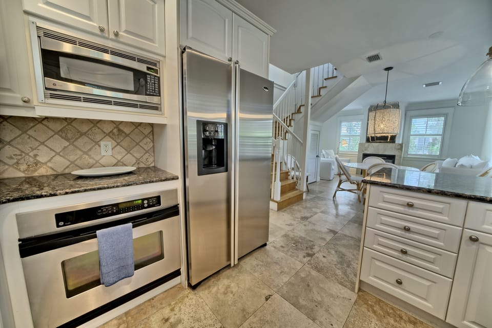 Kitchen has stainless steel appliances and granite countertops.