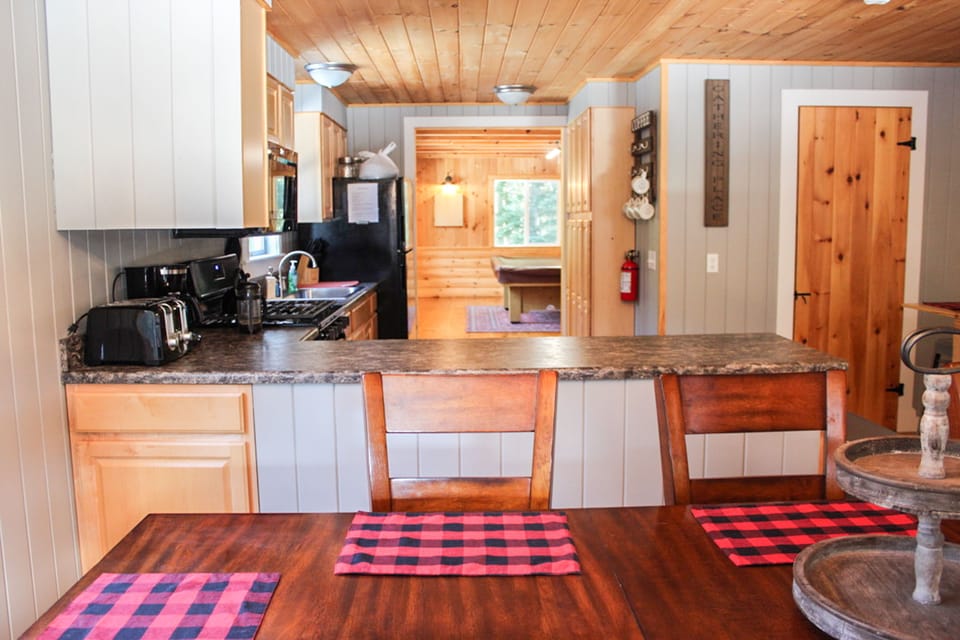 Table view into kitchen and game room (downstairs full bath is door to right)