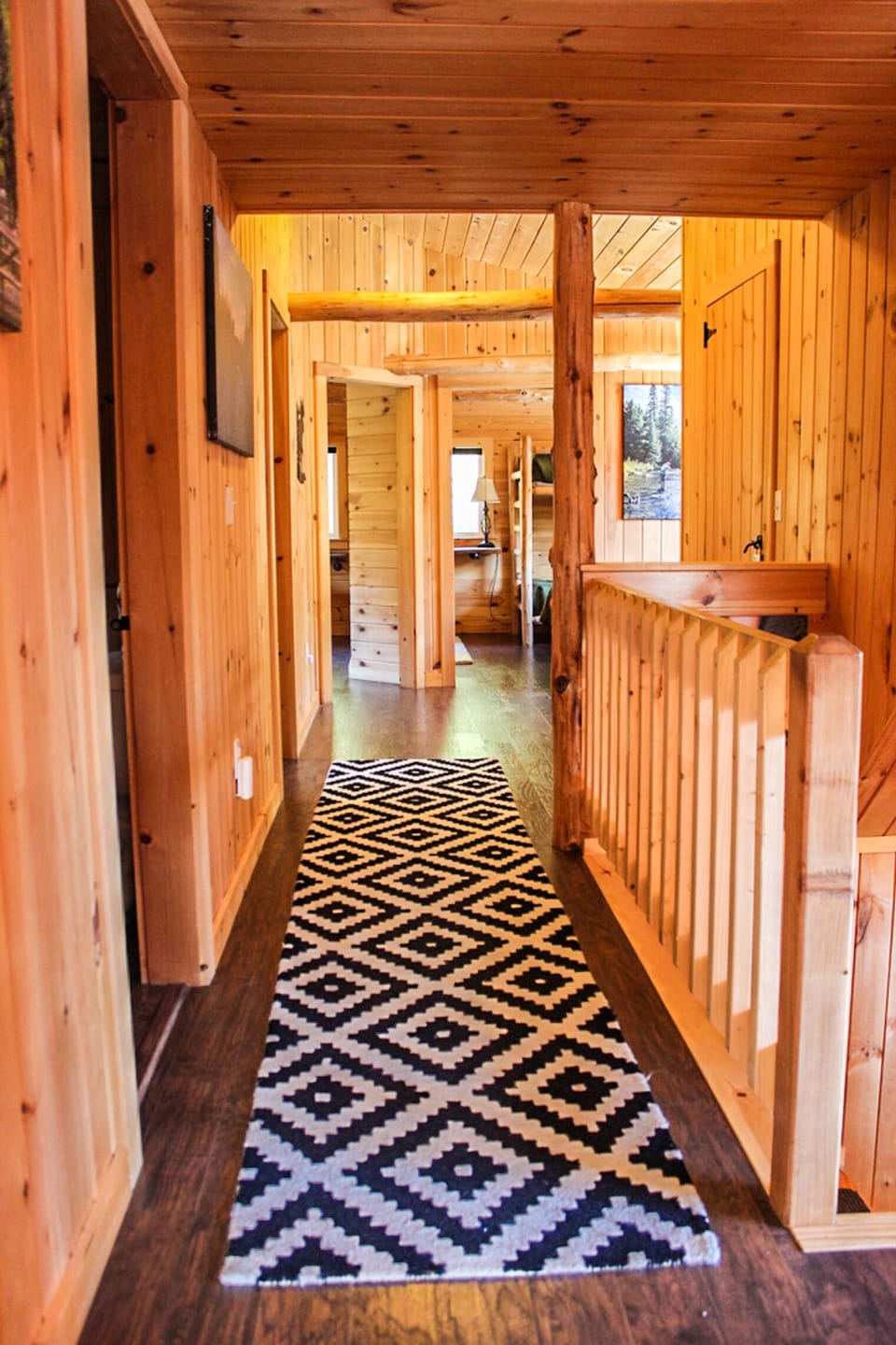 Second level hallway 5 bedrooms, one full bathroom and futon end of hallway