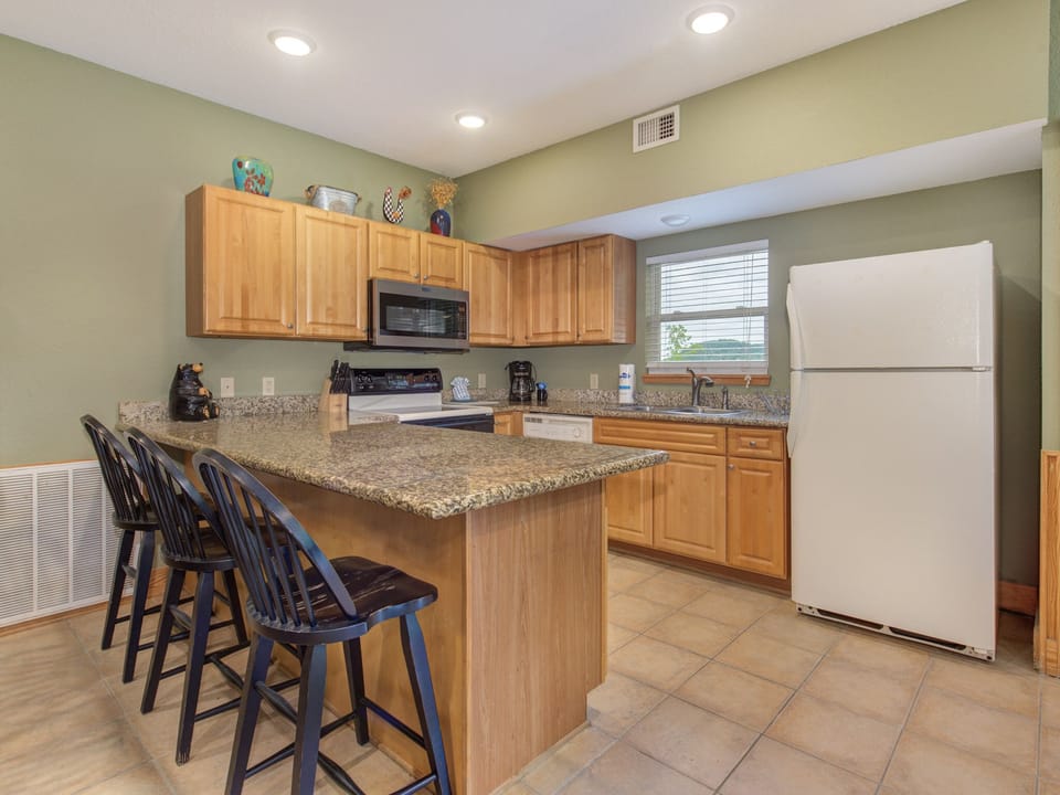 Fully Equipped Kitchen and Breakfast Bar Seating for Three
