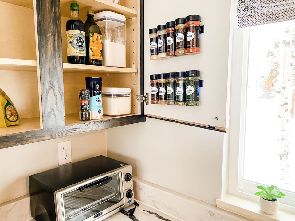 The kitchen is well stocked with spices and cooking essentials.