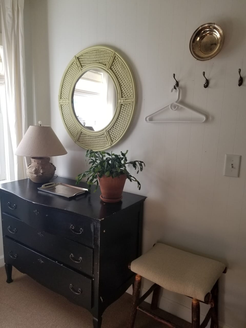 Lowboy dresser and hooks in guest room.  No closet.