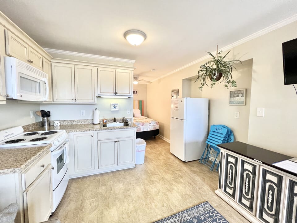 Kitchen equipped with basic appliances.