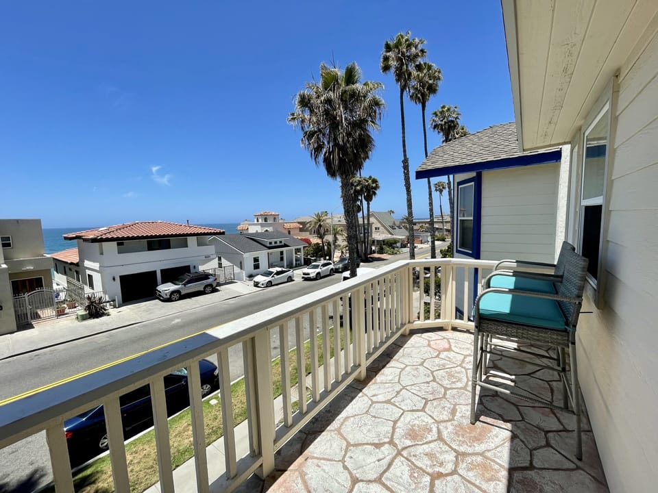 Main master balcony with 2 bar height chairs and ocean view.