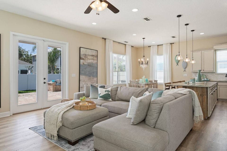 Bright open living room with views of the pool