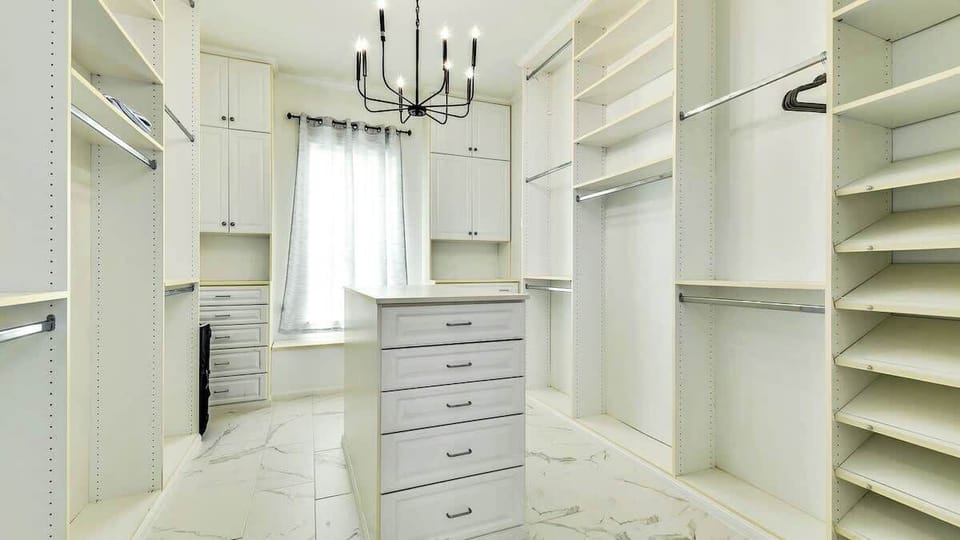 The primary closet is spacious and offers ample storage space