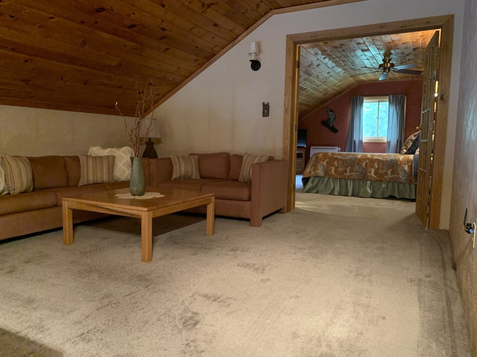 View of whole loft area. Double glass doors divide loft area