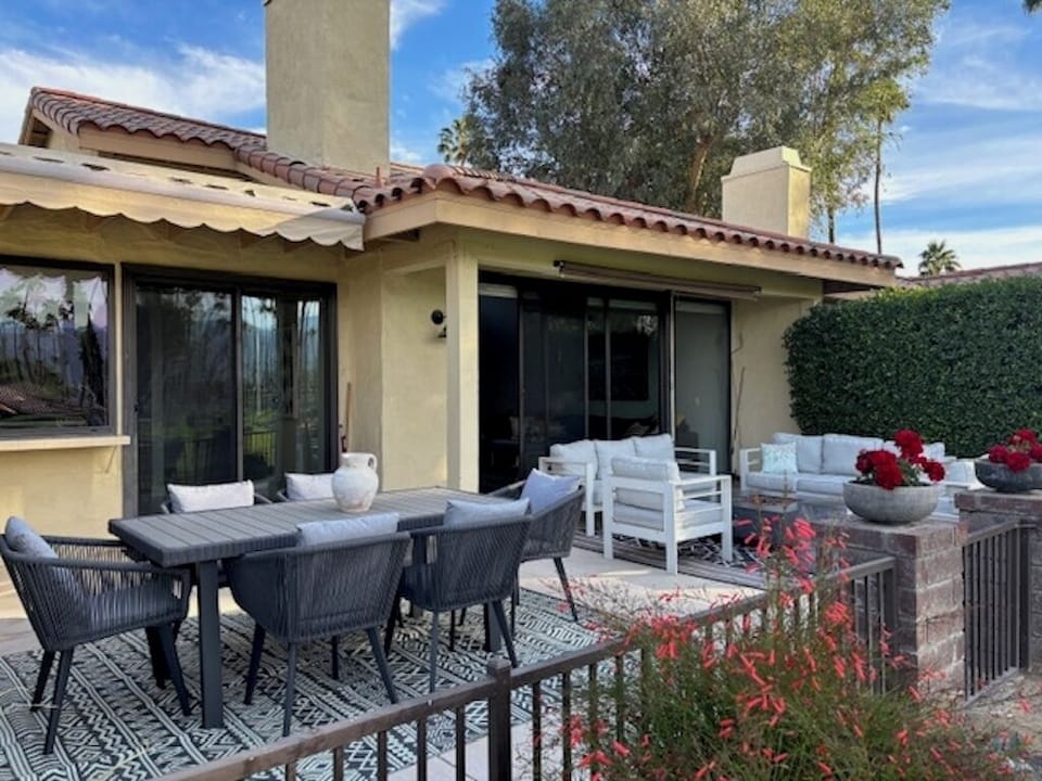 Huge back patio with sitting area, outdoor dining area, grill and fireplace. 