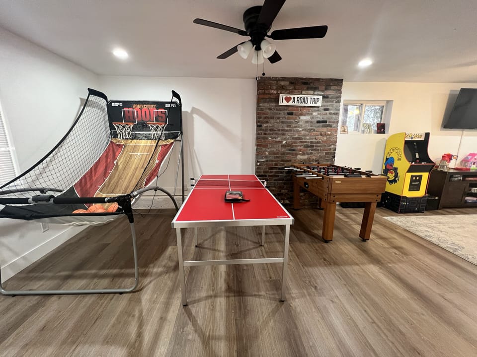 Game room with couch, TV and games