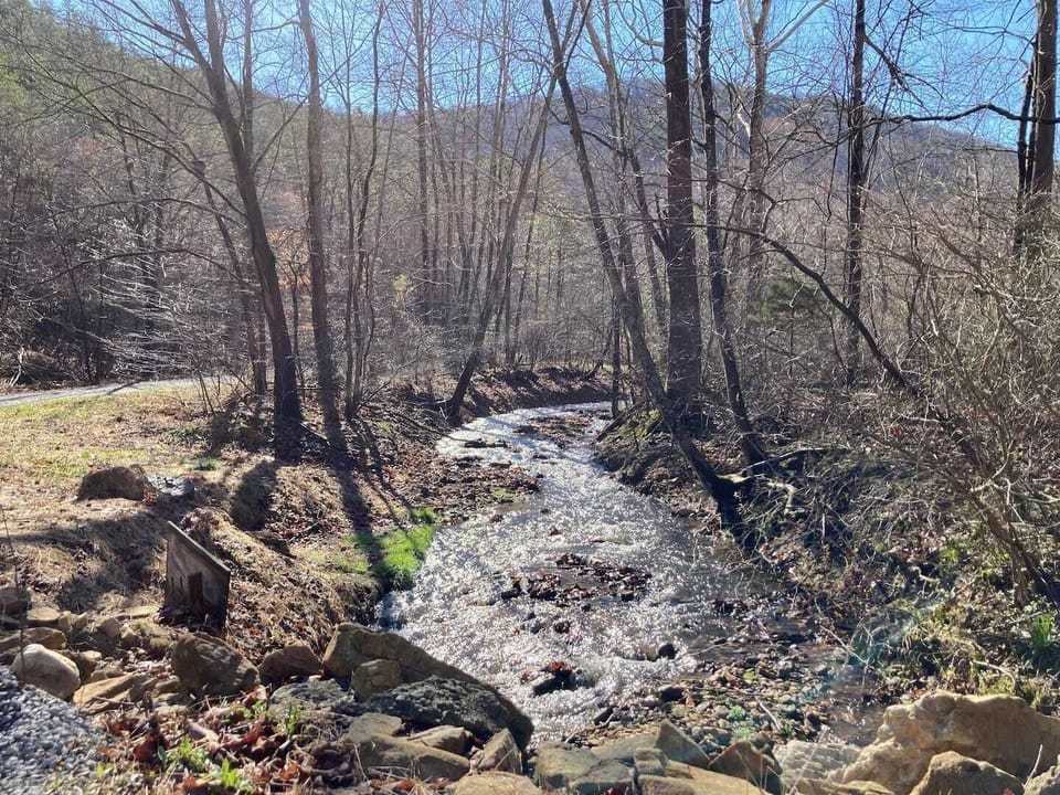 Small stream located along the front of the property.  This is a view from where you first enter and cross over the stream.