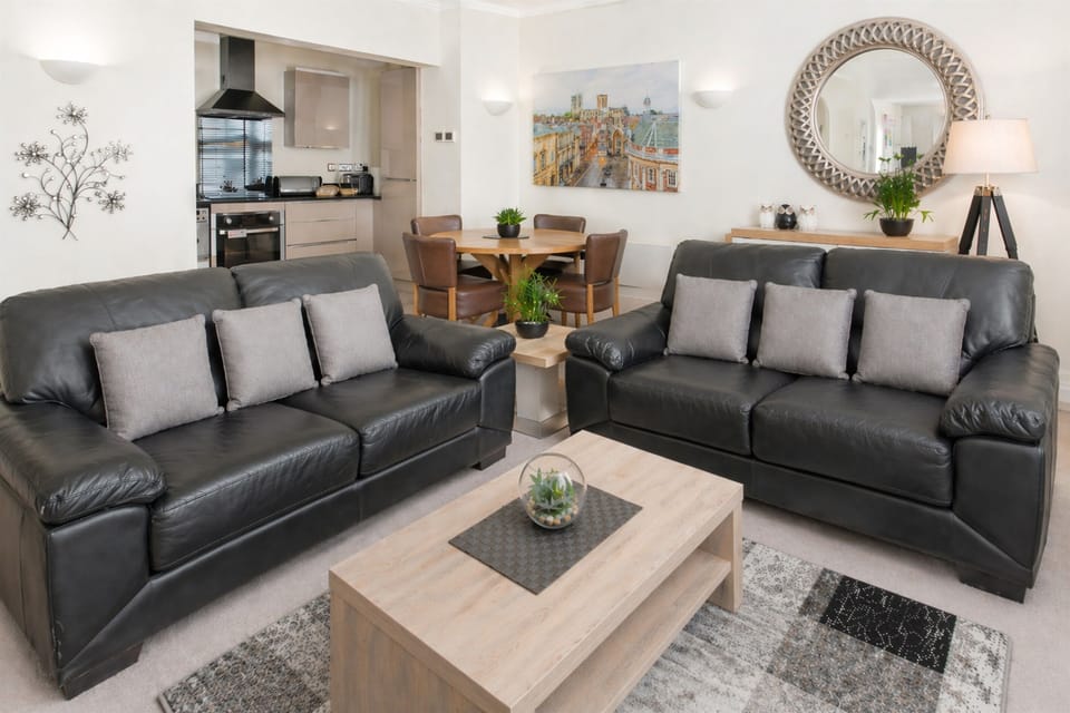 Bright open-plan living area with comfortable seating, dining space and a well-equipped kitchen.