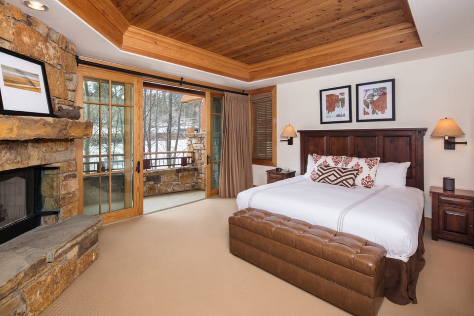 Master bedroom with fireplace and balcony.
