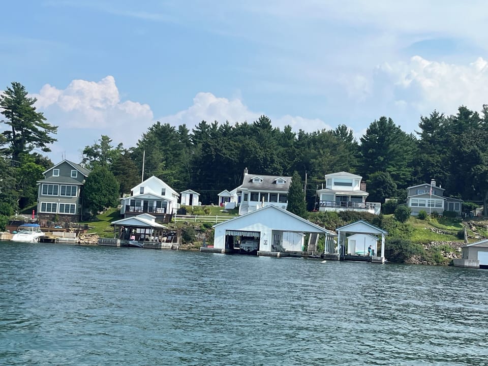 Blue Roofed Boatlift with Cottage above. House is Tallest one on this road.