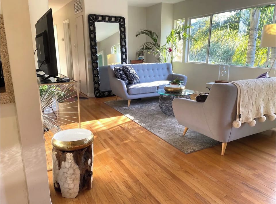 Main living room with views of hills, lots of natural light.