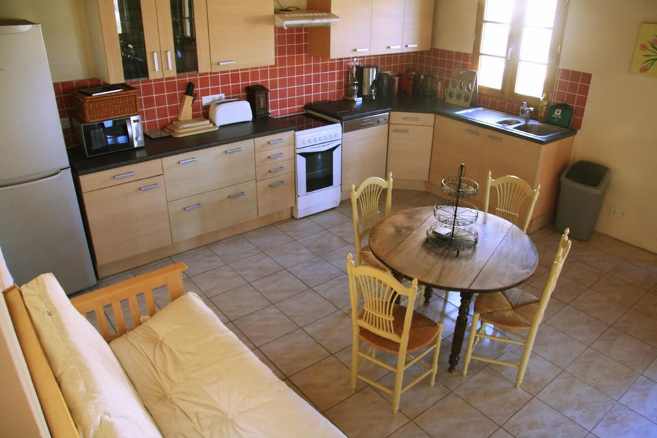Kitchen area. Large gîte kitchen and sofa bed
