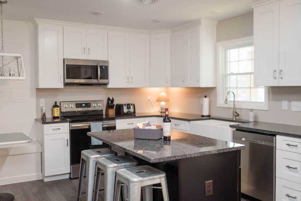 Large open kitchen, and island with three barstools