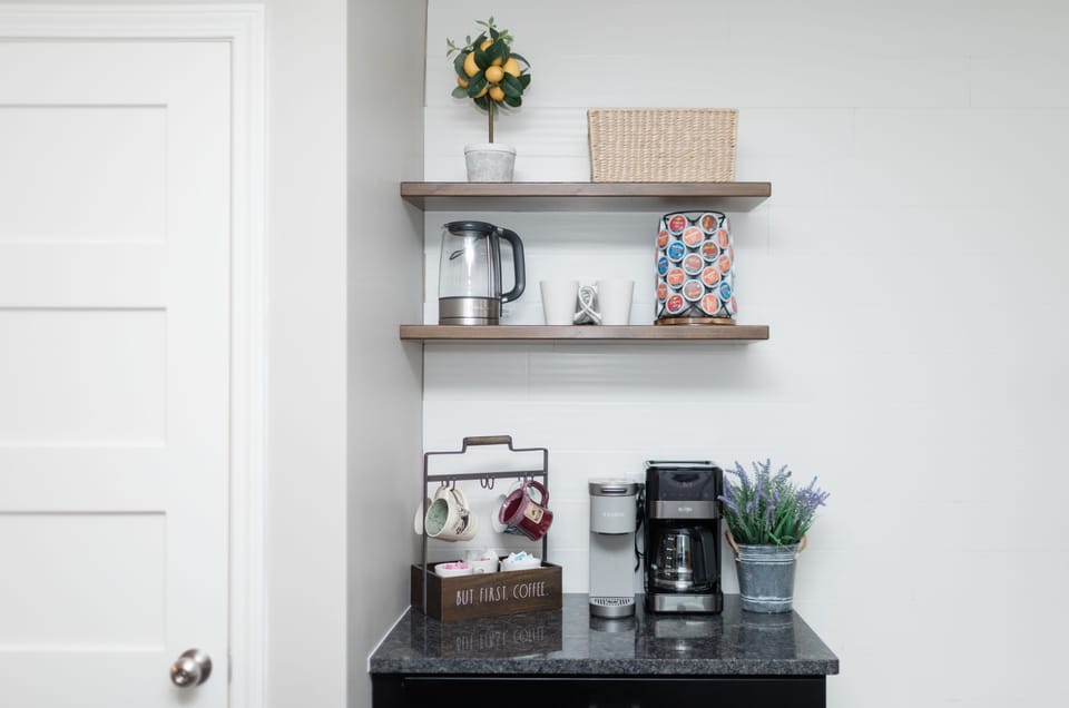 Coffee bar with a Keurig, a regular coffee pot, and a kettle.