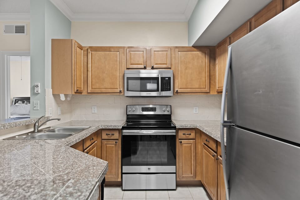 Kitchen features stainless steel appliances.