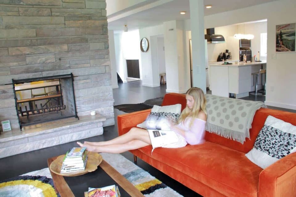 Open living room with open fireplace to the spacious dining room and dream kitchen. 