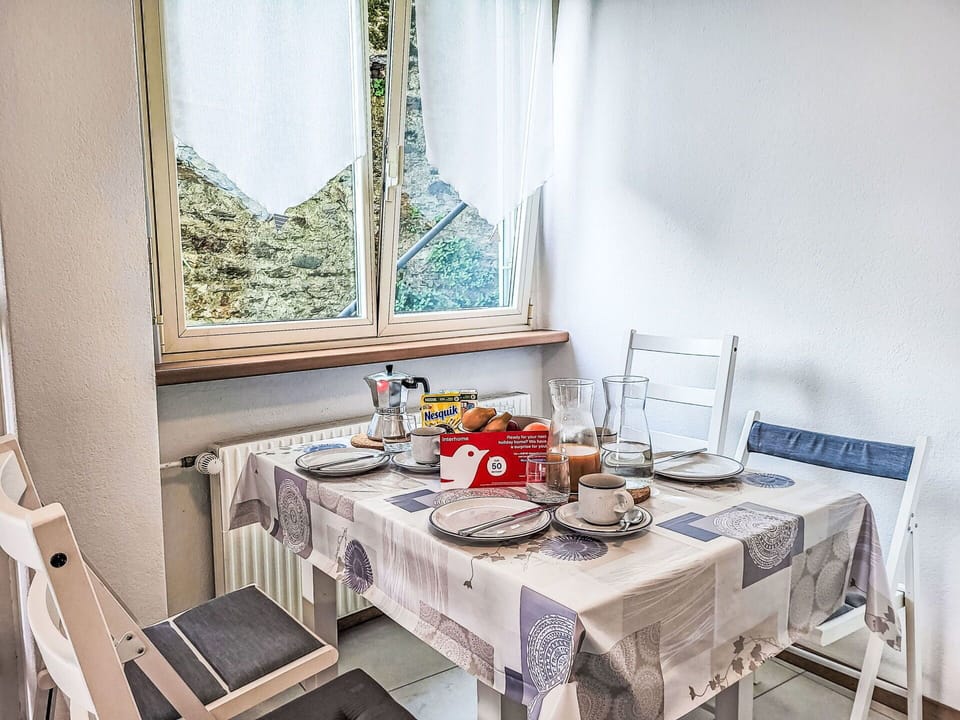 Furniture, Interior Design, Table, Tablecloth, Textile, Linens, Room, Lighting, Chair, Tableware