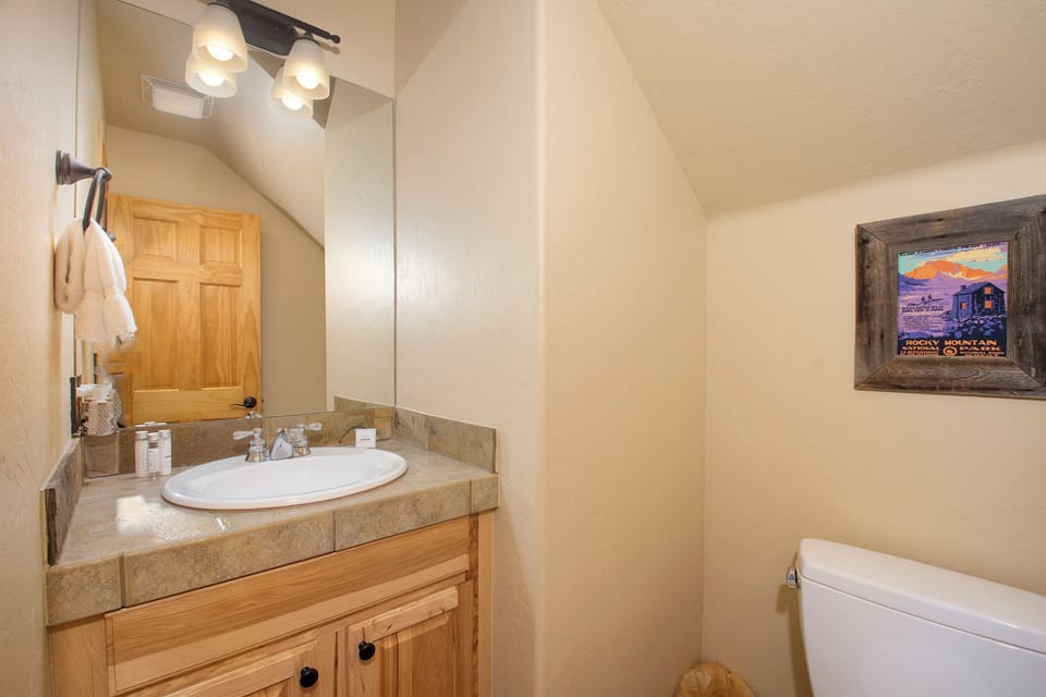 Freshen up in your cozy bathroom with warm lighting, granite counters, and thoughtful amenities.