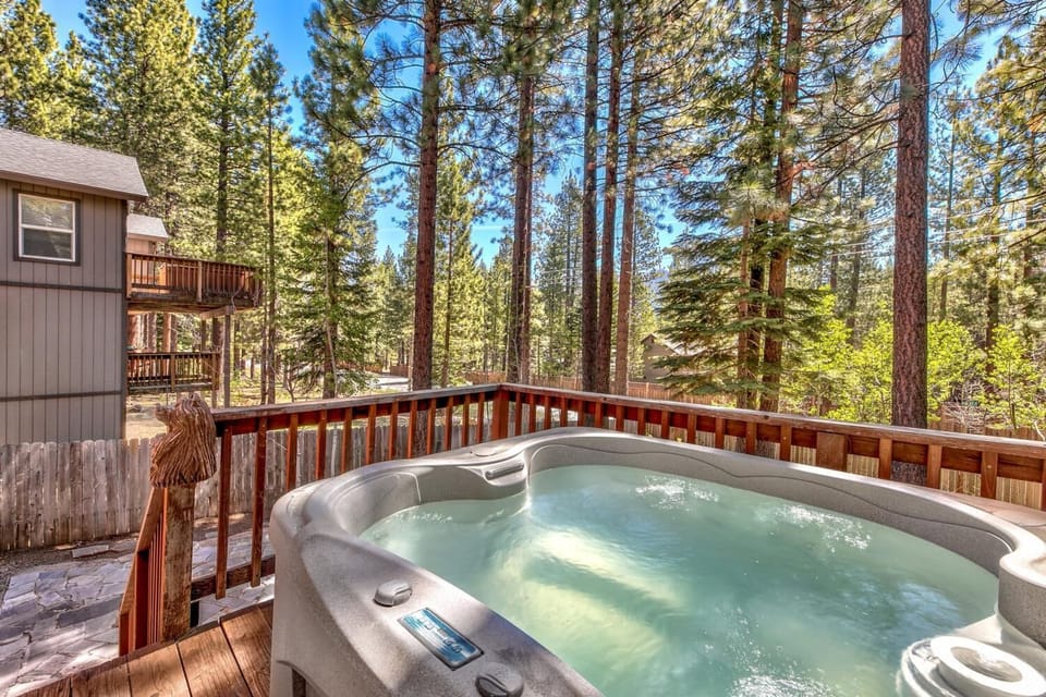 Soak your stress away in this private hot tub surrounded by towering pines and mountain serenity.