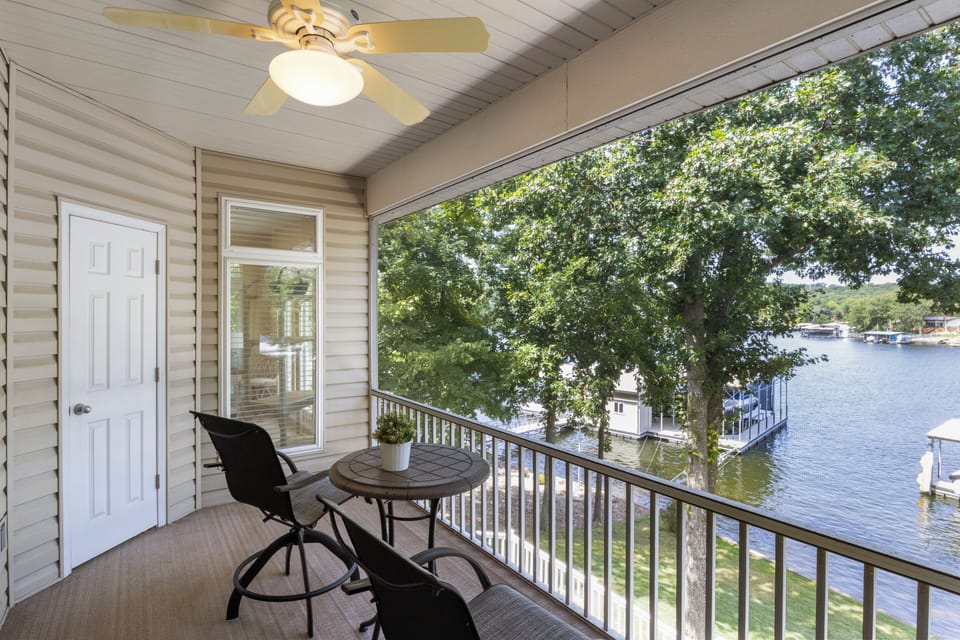 Relax on the cozy screened-in porch on upper level.