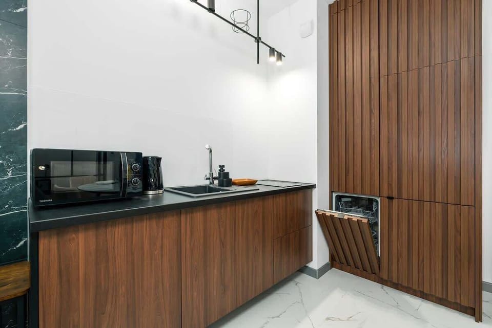 A modern kitchen with high-quality appliances ensures that home-cooked meals can be prepared. 