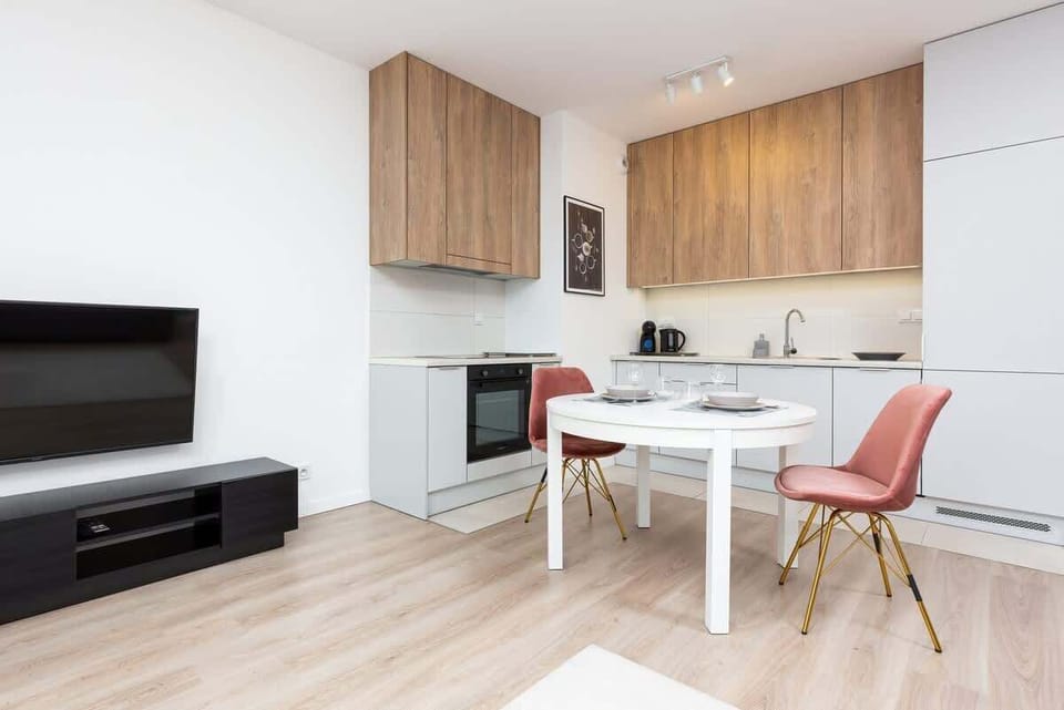 Functional kitchenette with white cabinets oven and appliances that provide for home-cooked meals.