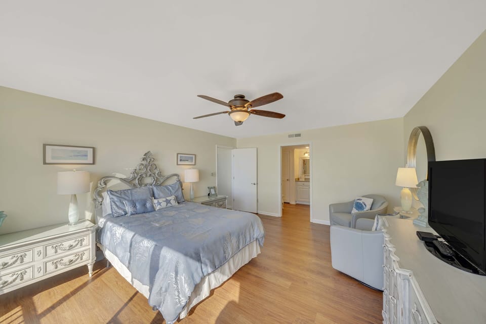 The first master bedroom features a Queen size bed, television, incredible views, and ensuite bathroom.